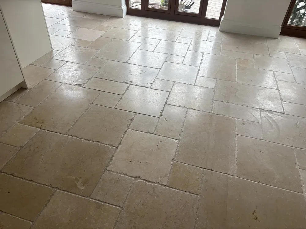 Limestone floor rescued from six months of building dust, before restoration